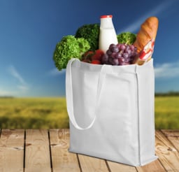 Custom bag made of bamboo filled with various groceries 