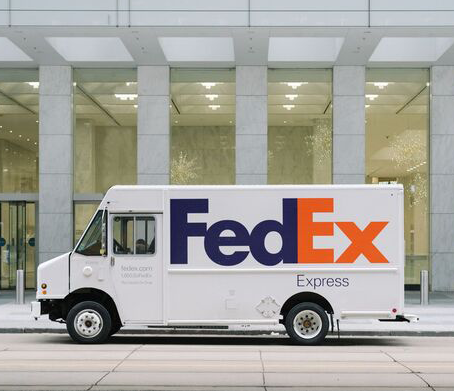 Fedex express truck stopped at side of road to deliver boxes
