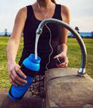 Women filling up blue eco-friendly plastic bottle - Click here for BPA free custom bottles