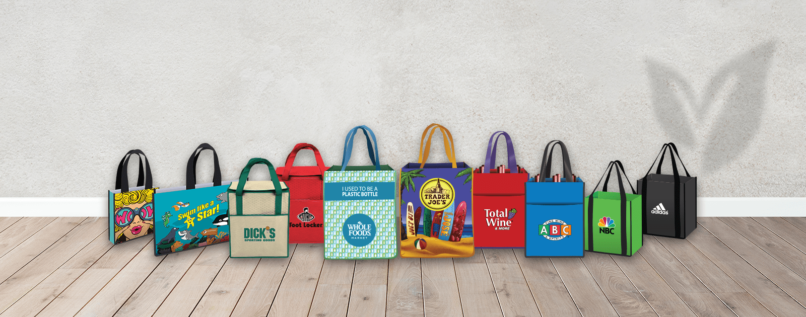 Reusable bags lined up together with unique custom logos and varying colors